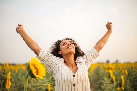 pexels photo 3756168 3756168 2 Joyful woman with arms raised in a sunflower field, embracing freedom and happiness.