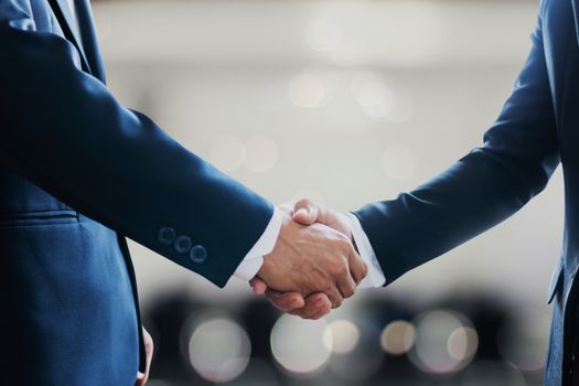 pexels photo 4161612 4161612 Close-up of business professionals in suits shaking hands, symbolizing a successful collaboration or agreement.